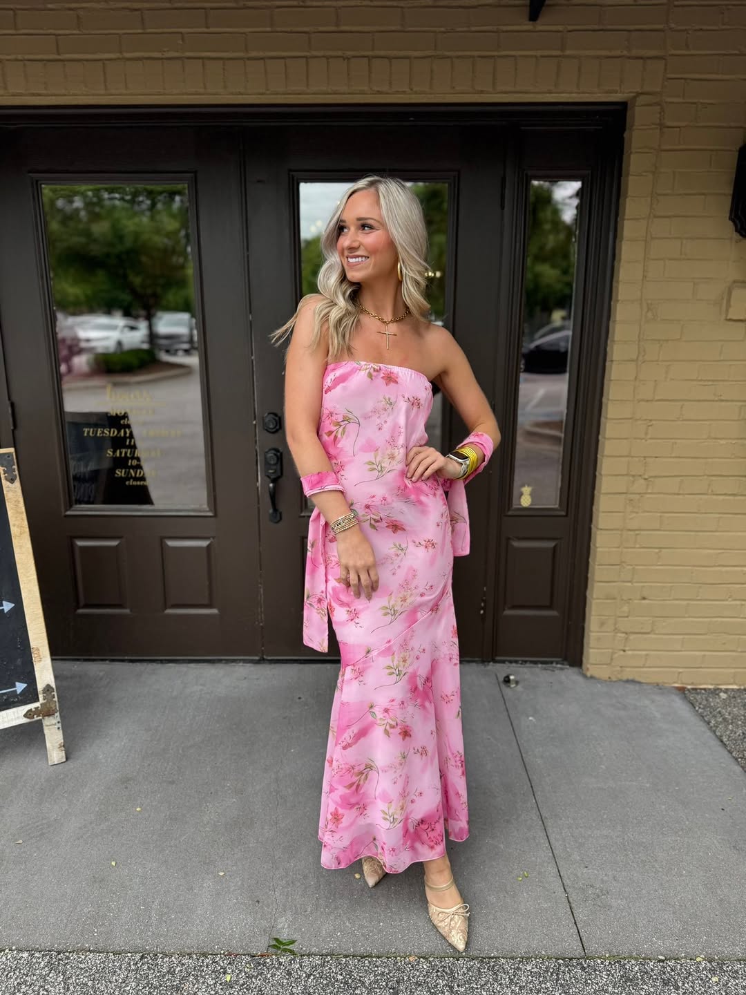 Pink floral strapless midi at the boutique door